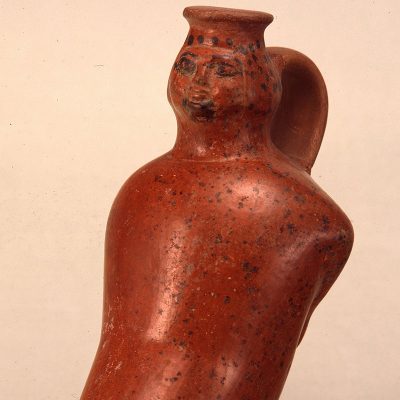 One handled vase in the shape of a kneeling female figure. New Kingdom. Dynasty XVIII. Amenhotep III (1402-1364 BC).