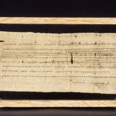 Part of papyrus sheet bearing greek script, written in black ink. Ptolemaic Period, 252 B.C. Dimensions: 0.317 x 0.135 m.
