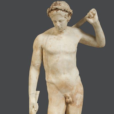 Marble statuette of a youth wearing a wreath in his hair.
End of the 1st c. BC