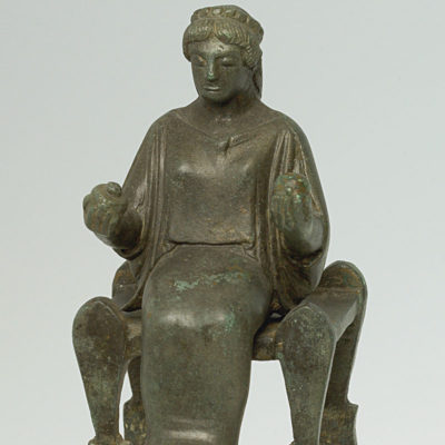 Bronze figurine of a seated goddess. From the sanctuary of Demeter and Kore at Ayios Sostis in Arcadia. A work in the tradition of northeastern Peloponnese, and especially Argos. About 470 BC (X 14922).