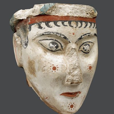 Μοναδική πλαστική γυναικεία κεφαλή από ασβεστοκονίαμα, μορφή θεάς ή σφίγγας, από τα ελάχιστα δείγματα της μυκηναϊκής μεγάλης πλαστικής. Από την περιοχή του Θρησκευτικού Κέντρου της ακρόπολης των Μυκηνών. 13ος αι. π.Χ.