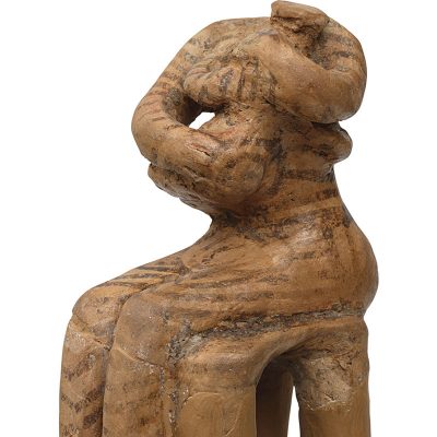 ''The Nurse''. Clay figurine of a woman sitting on a stool with an infant in her arms. Sesklo (Thessaly), 4800-4500 BC.