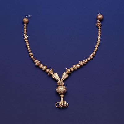 Gold necklace with beads of various shapes, some with granulated decoration, and lily-shaped pendant. Dendra, Tomb 10.